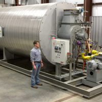 employee standing by a newpoint thermal hot oil heater